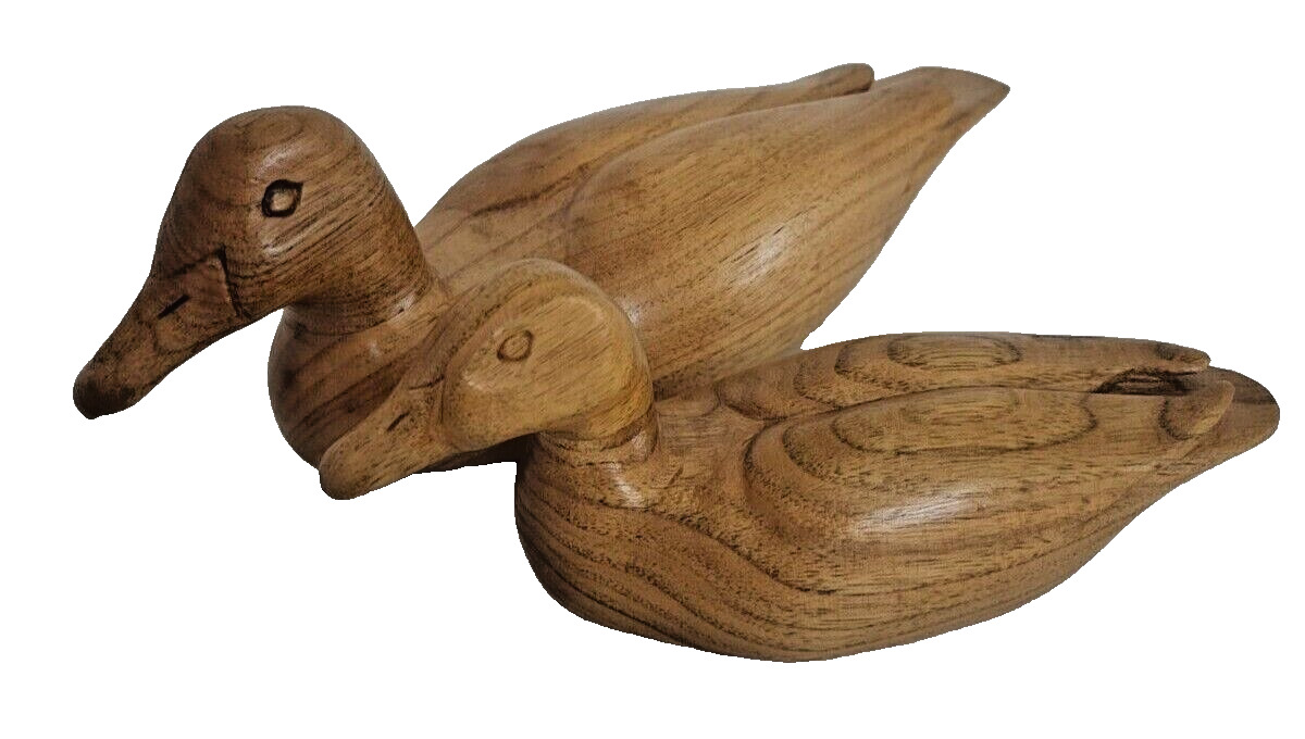Pair of ducks carved from wood. Love the carved details. Beautiful wood grain