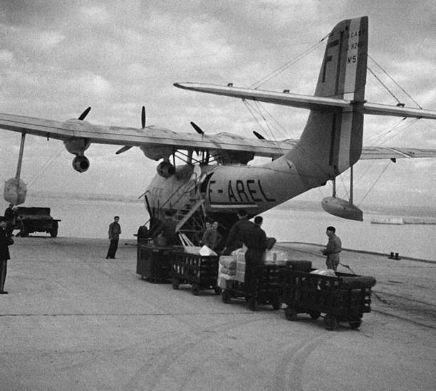 Personnel loading parcels luggage into hold of an aircraft Marigna- Old Photo 2 Personnel loading parcels luggage into hold of an aircraft Marigna- Old Photo 2