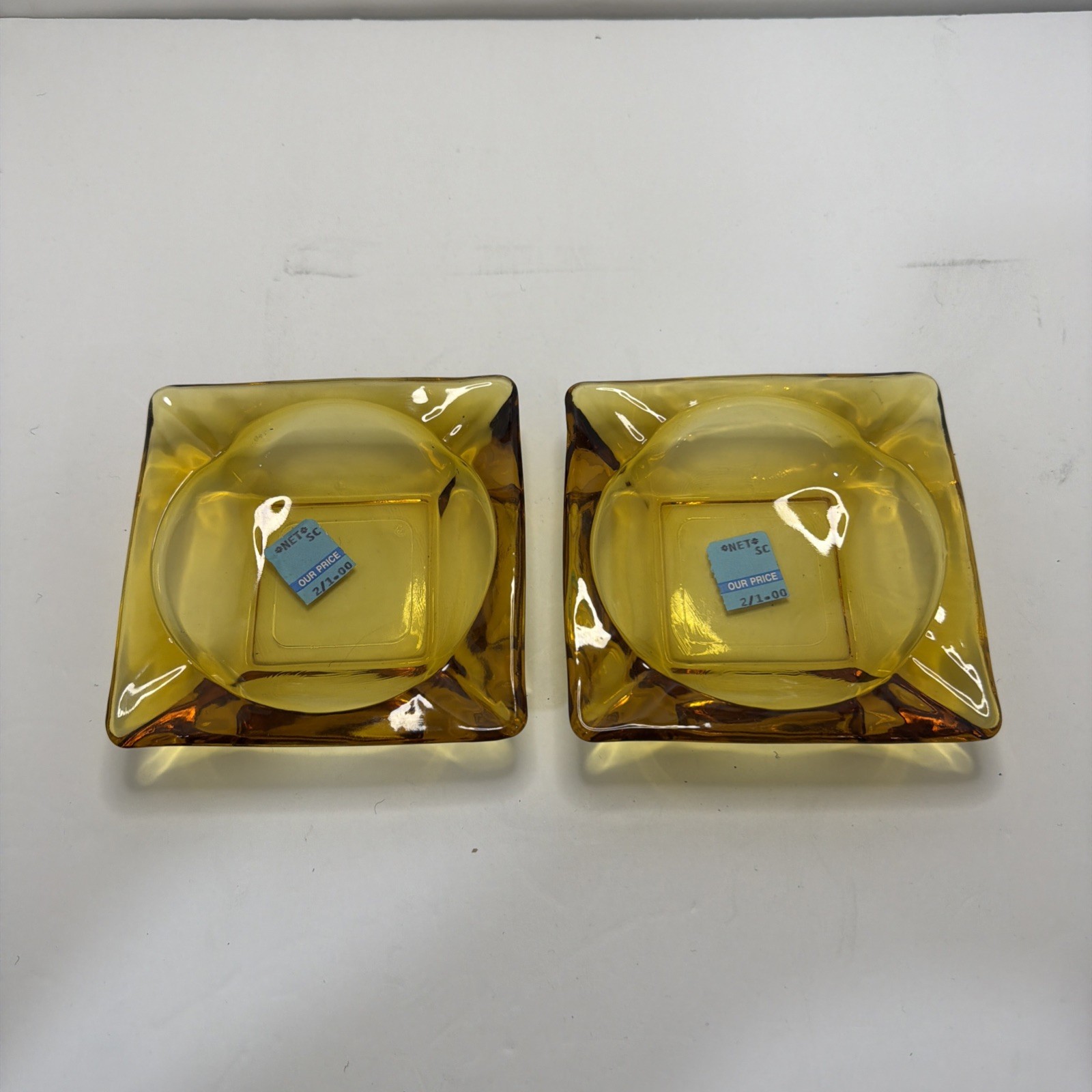 Vintage 1970s Mid Century Modern Amber Glass 4 Slot 4.5" Square Ashtrays (2) Vintage 1970s Mid Century Modern Amber Glass 4 Slot 4.5" Square Ashtrays (2)