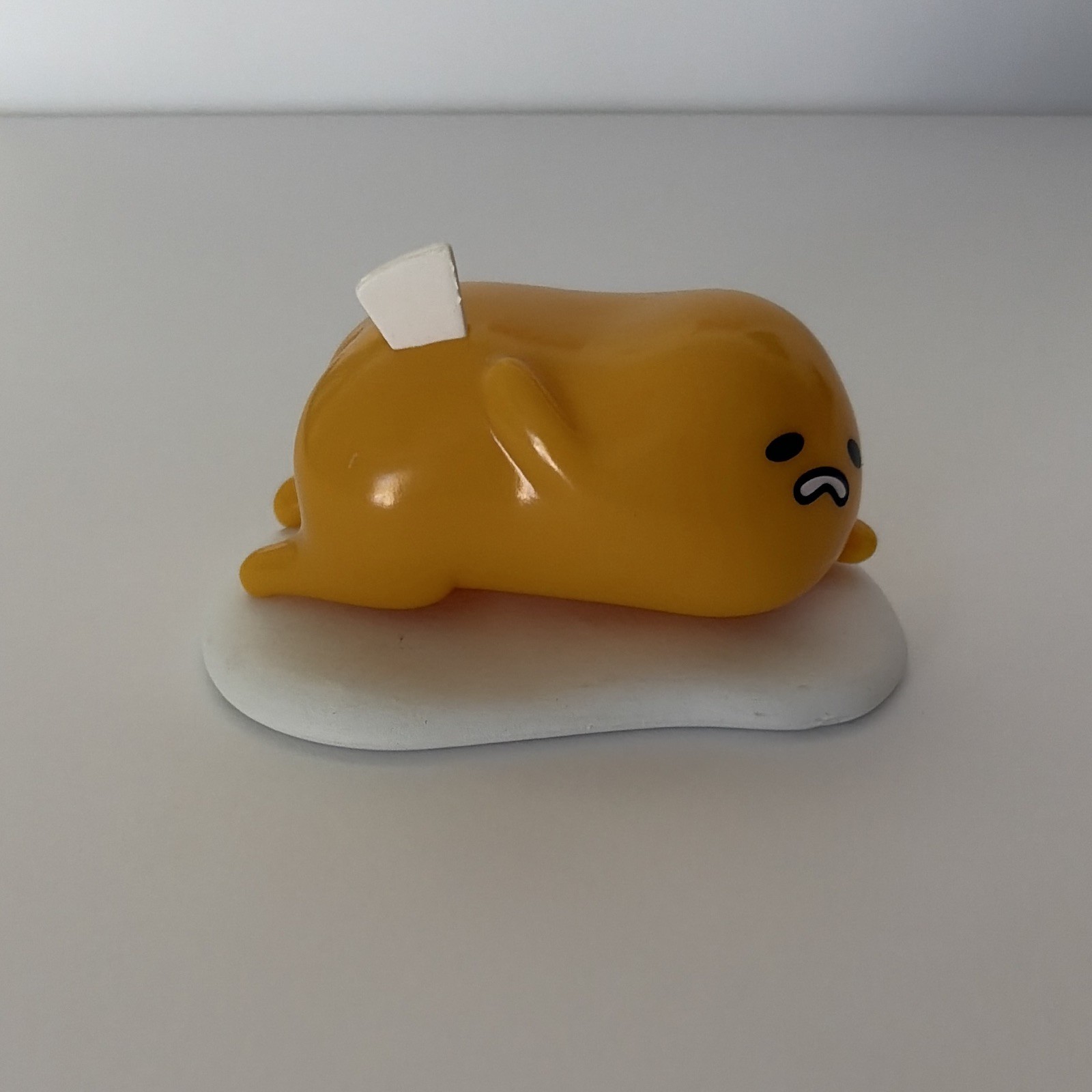 Sanrio Gudetama laying down on egg white. Figurine. figure. Unboxed Sanrio Gudetama laying down on egg white. Figurine. figure. Unboxed