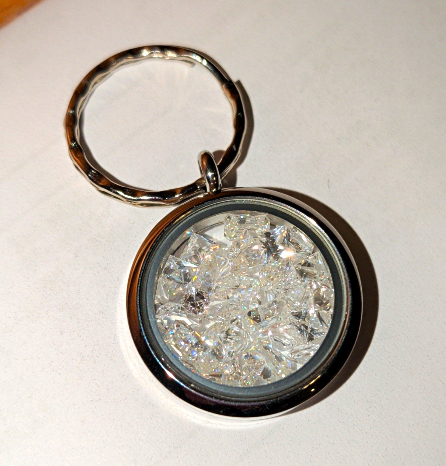 Silver Tone Round Metal Keychain w/ White sapphires, multi-shape. 