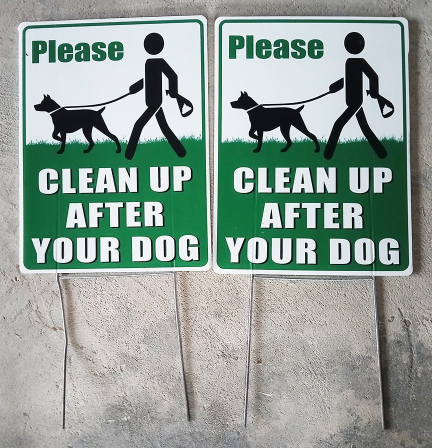 PREOWNED AND USED TWO PLASTIC "PLEASE CLEAN UP AFTER YOUR DOG" SIGNS FOR YARD