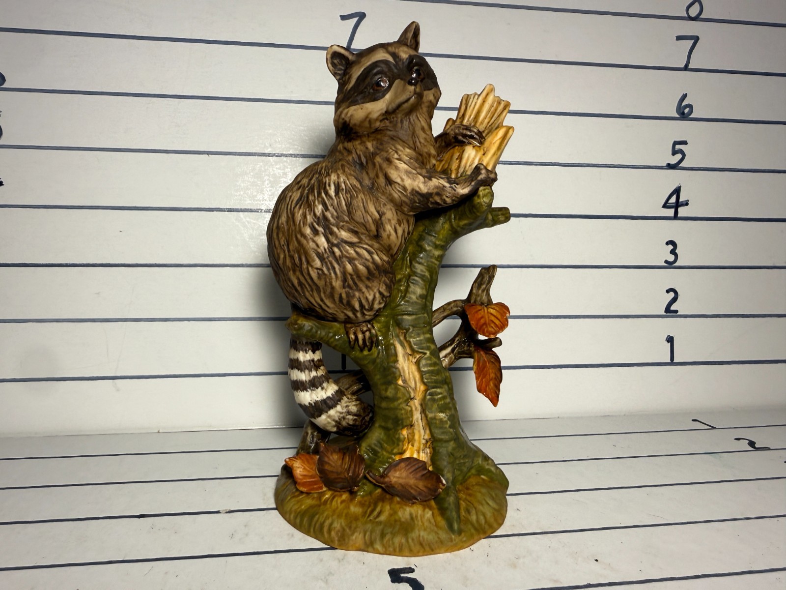 Porcelain Raccoon Procyon lotor Figurine by Stefani sitting on a stump in fall