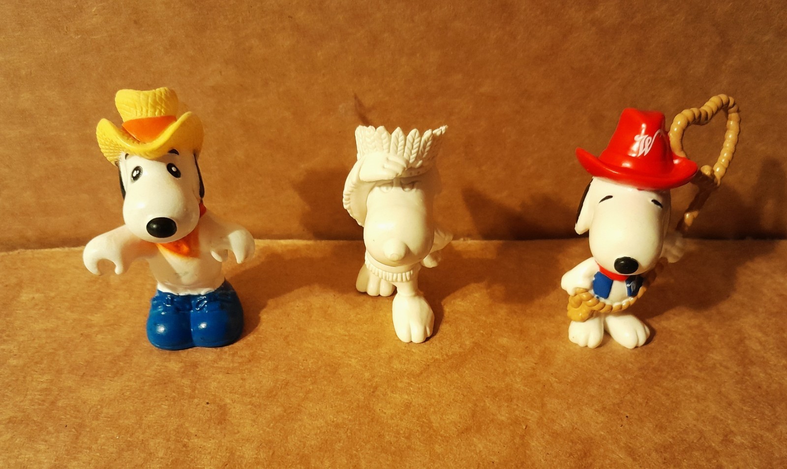Three Vintage Snoopy PVC Figures - Cowboys and Indians Three Vintage Snoopy PVC Figures - Cowboys and Indians