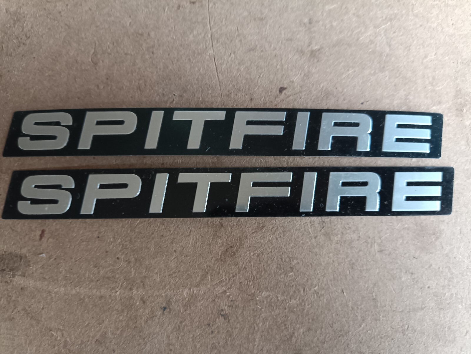  2 TRIUMPH SPITFIRE BADGE INSERTS EMBOSSED. NOS? Bargain price. 