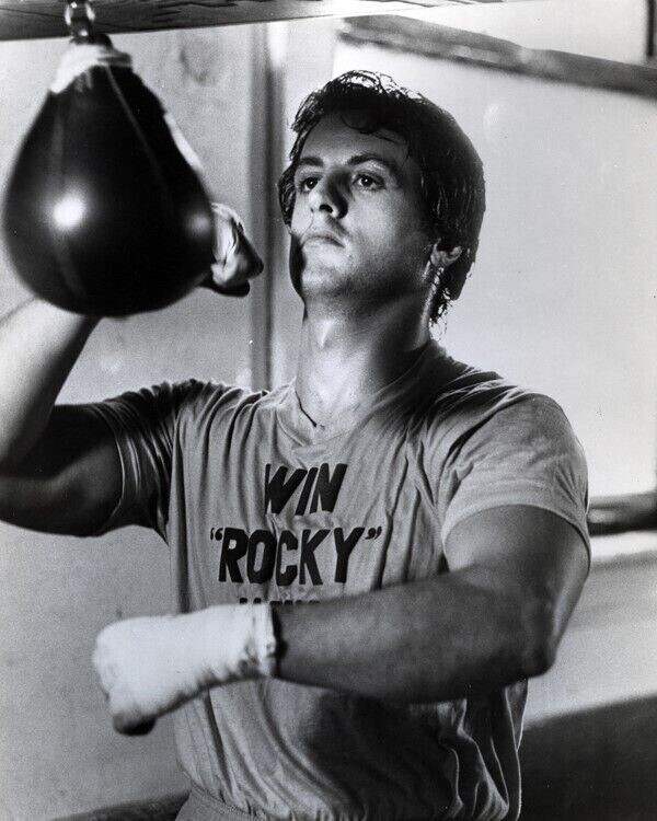 Sylvester Stallone belts punching bag in 1976 Rocky 11x17 inch poster Sylvester Stallone belts punching bag in 1976 Rocky 11x17 inch poster