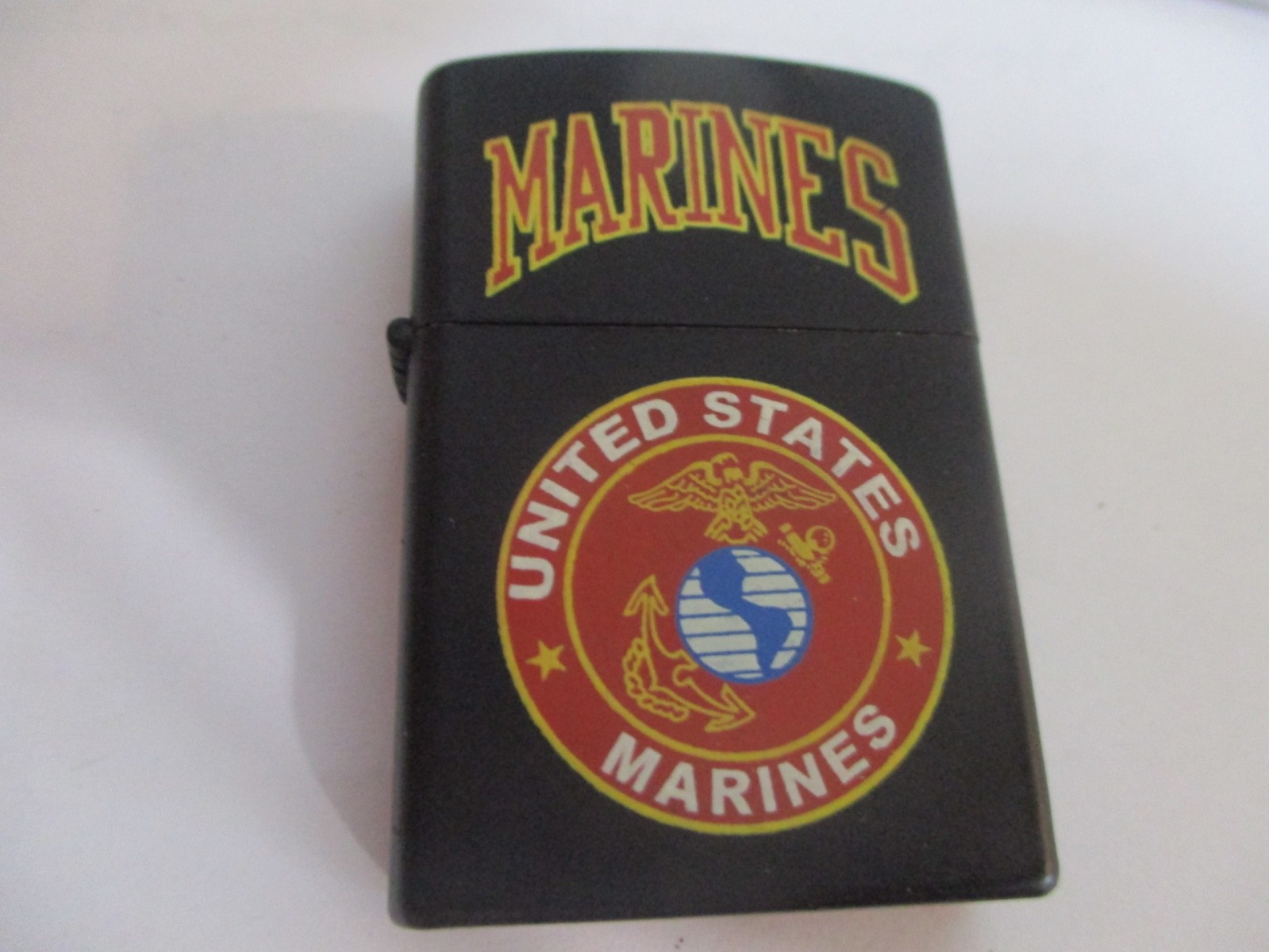 VINTAGE MARINES  TOBACCO BLACK LIGHTER .  MAY NEED SERVICE TO WORK.  VGC