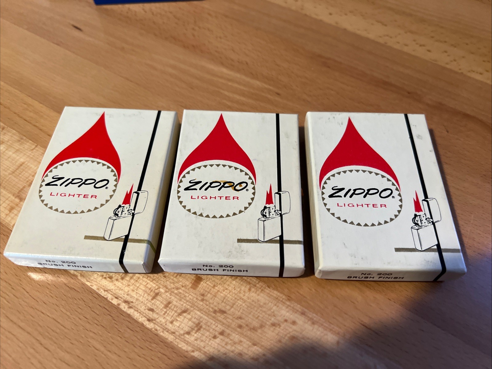(3) NOS No. 200 Brush Finish Zippo lighters from 1974-75 Engraved South Korea (3) NOS No. 200 Brush Finish Zippo lighters from 1974-75 Engraved South Korea