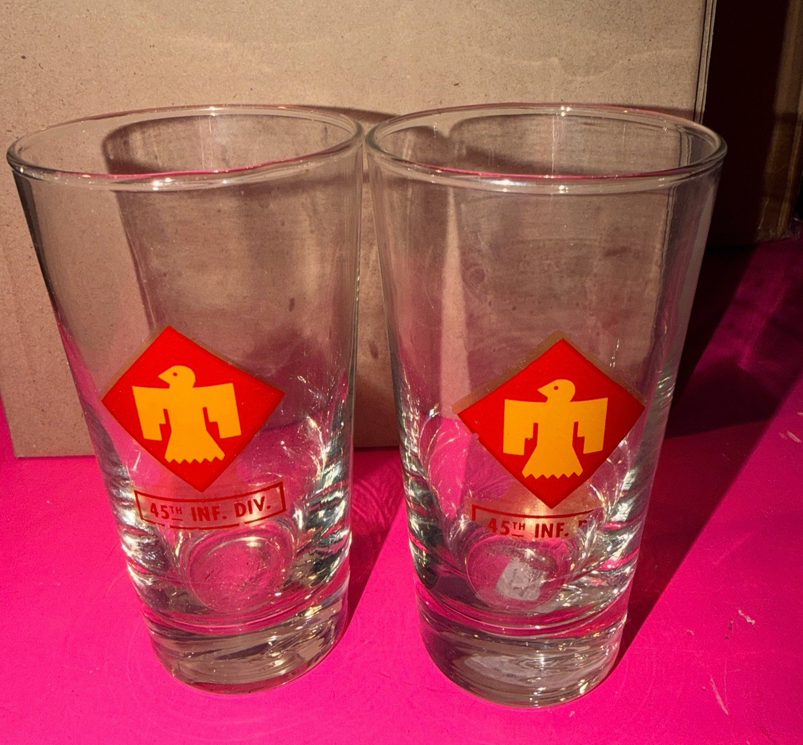 Two vintage 45th Infantry Division “Thunderbird” drinking glasses. Two vintage 45th Infantry Division “Thunderbird” drinking glasses.