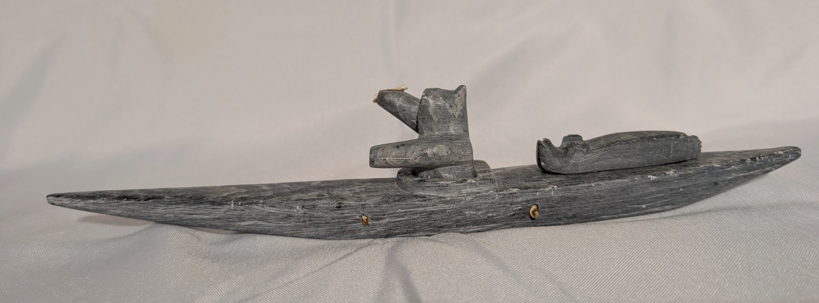 Inuit Eskimo Stone Carving Of  Hunter in Canoe With Seal Laying On Bow