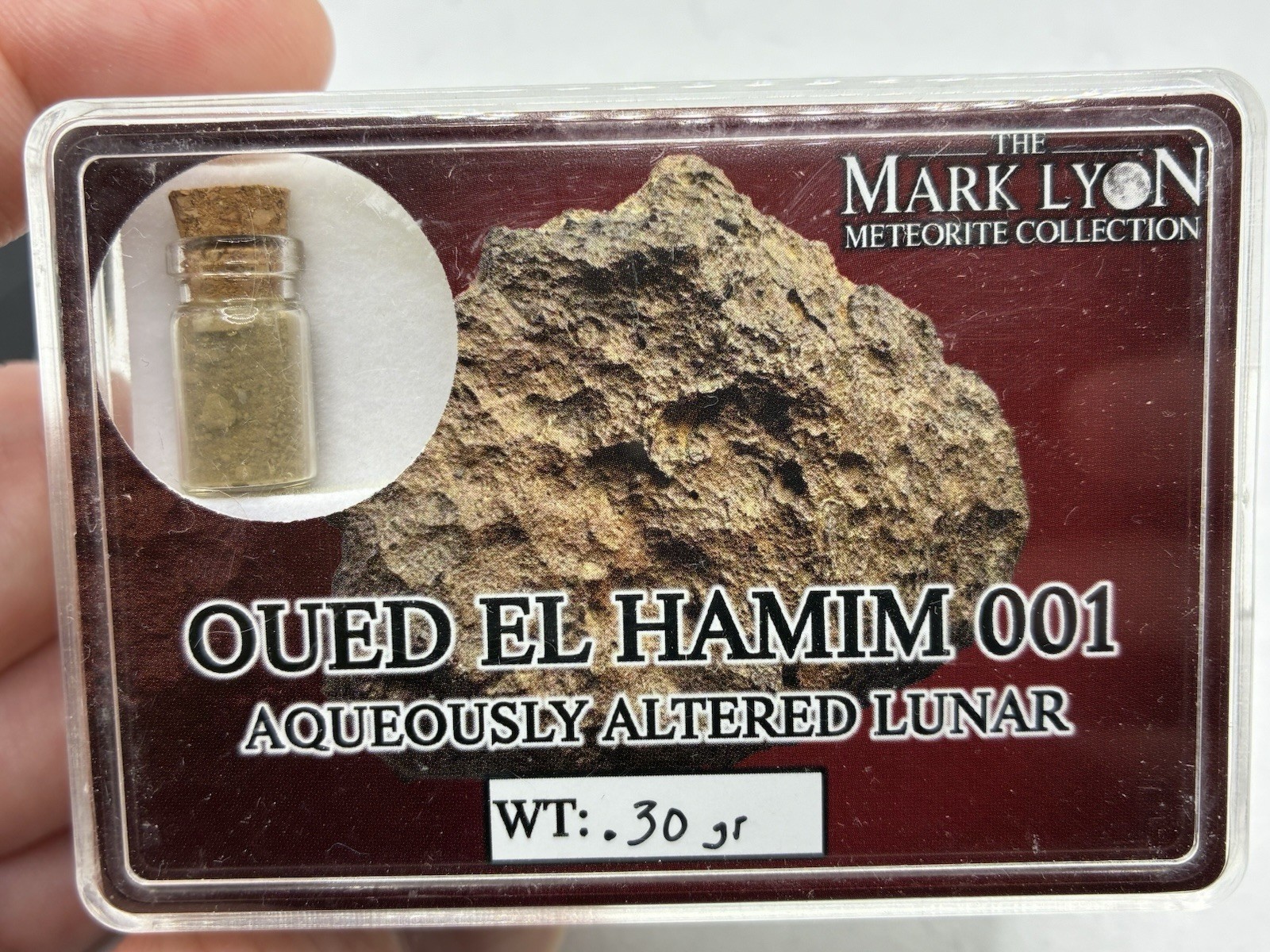 Authentic Oued El Hamim 001 Lunar Meteorite Vial (0.30g) – Mark Lyon Collection Authentic Oued El Hamim 001 Lunar Meteorite Vial (0.30g) – Mark Lyon Collection
