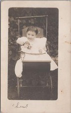 RPPC Postcard Little Girl In Baby Carriage Holding China Doll picture