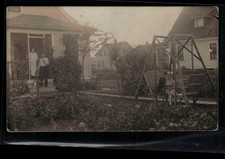 RPPC Postcard Backyard Scene, Girl with Dog on Chair, Water Pump c1914 - Trimmed picture