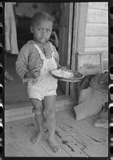 Photo:Southeast Missouri 1938 Child of Sharecropper Eating on Porch picture