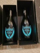 Dom PƩrignon. Luminous Collection A glowing empty bottle with a box. picture