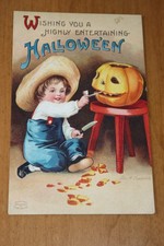 Antique Clapsaddle Halloween Postcard with boy carving a pumplin, picture