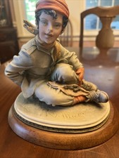 B Merli Capps Figurine of A boy Either A Dog picture
